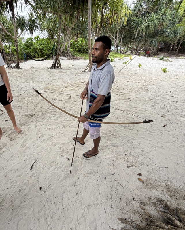 Guide demonstrating traditional bowhunting on the beach