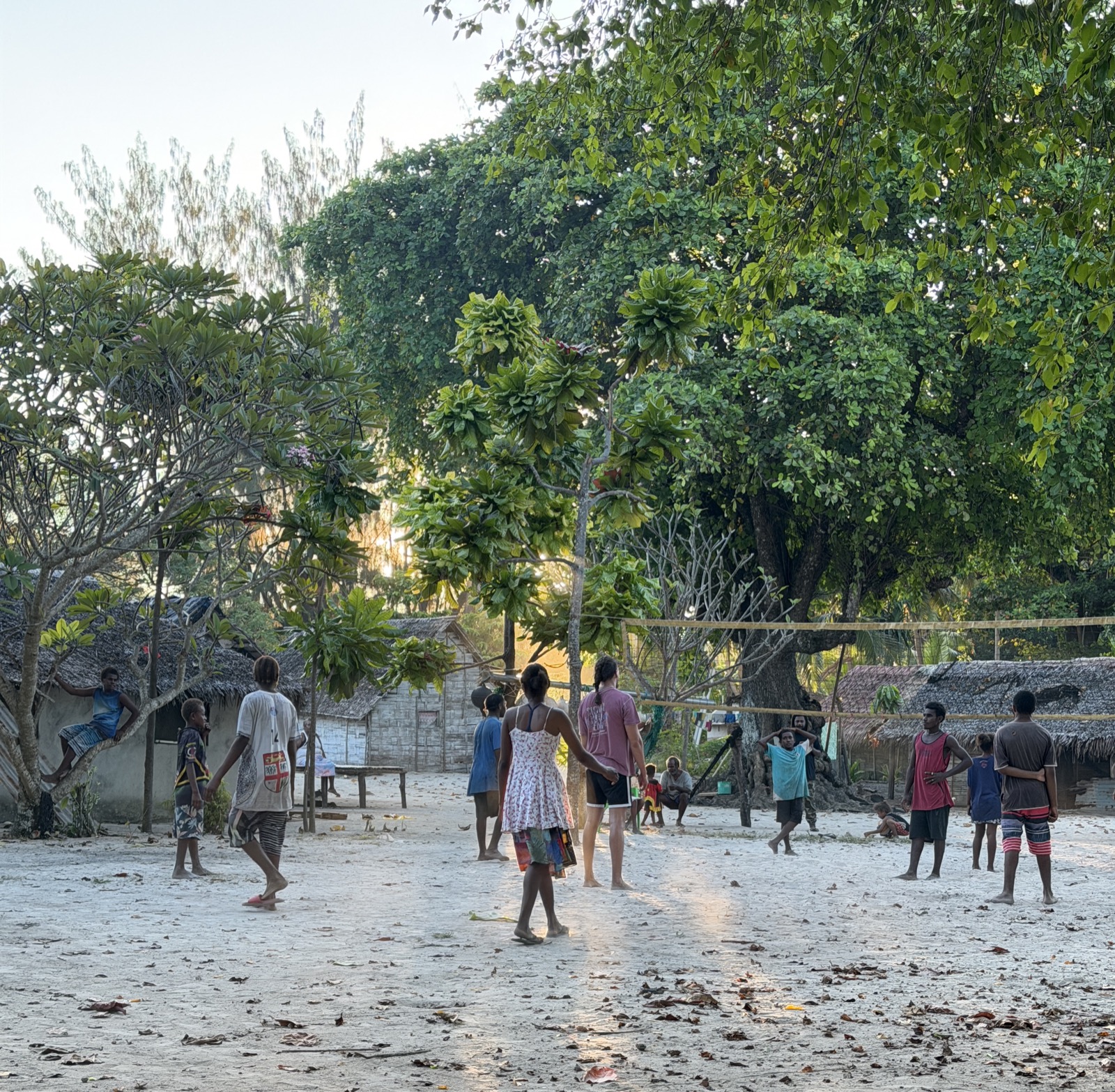Villagers playing volleyball together in the village square on Loh Island
